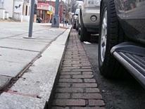 photo of a granite curb and brick-lined gutter on District street