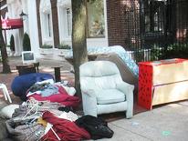 photo of furniture and household items on the curb