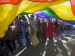 people under giant rainbow flag